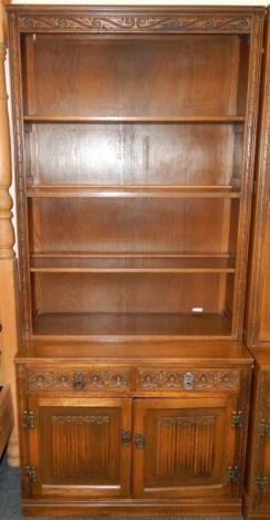 An Old Charm oak cupboard bookcase