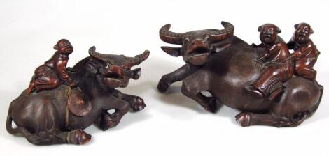 A graduated pair of Chinese water buffalo figures