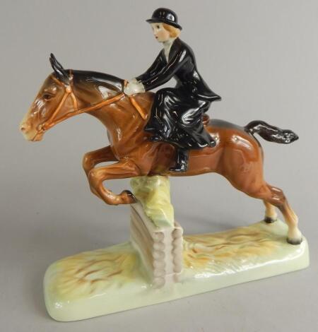 A Beswick model of a huntswoman leaping a fence