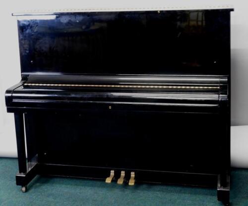 An Apollo ebonised upright piano