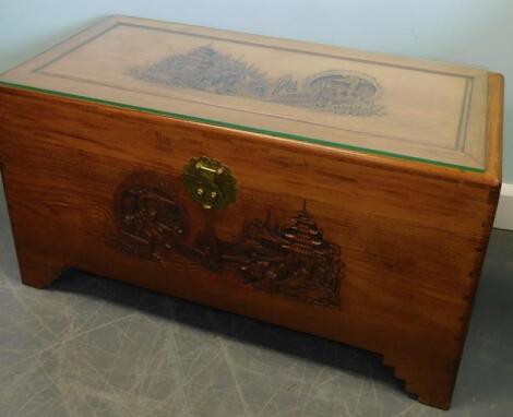 A 20thC carved Oriental camphorwood chest