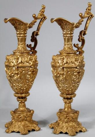 A pair of 18thC style cast metal rococo style ewers