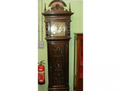 A carved oak longcase clock with brass dial inscribed W. Sellers