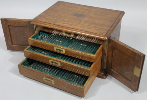 An early 20thC oak cased canteen of silver plated cutlery