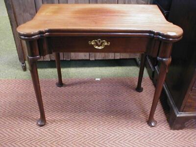 A 18thC mahogany card table with shaped folding top revealing a baize lining