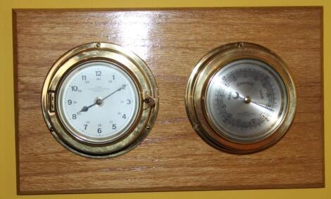 A modern wall hanging barometer and thermometer