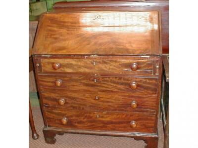 A George III mahogany bureau with fall flap revealing a fitted interior