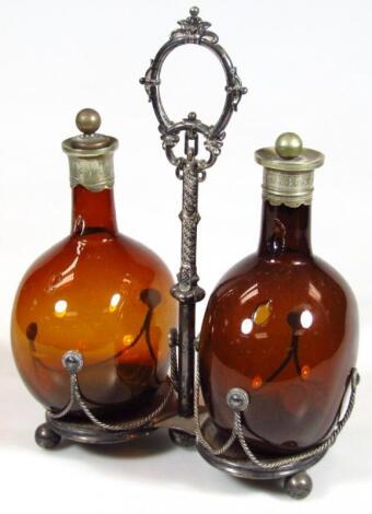 A late 19thC amber glass cruet bottle set