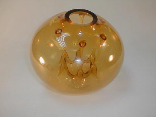 A Venetian globular amber glass sculpture with internal bubble and legs