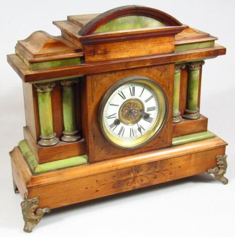 An early 20thC carved wooden mantel clock