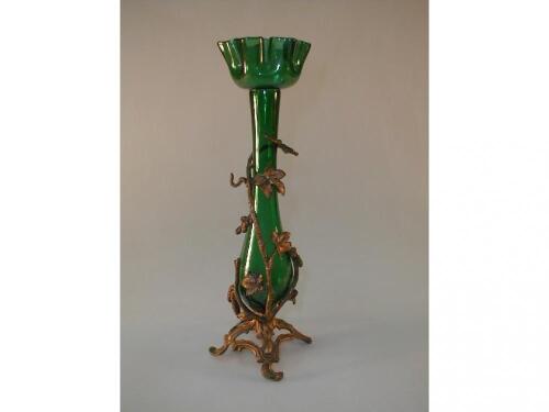 A green glass vase of slender baluster form