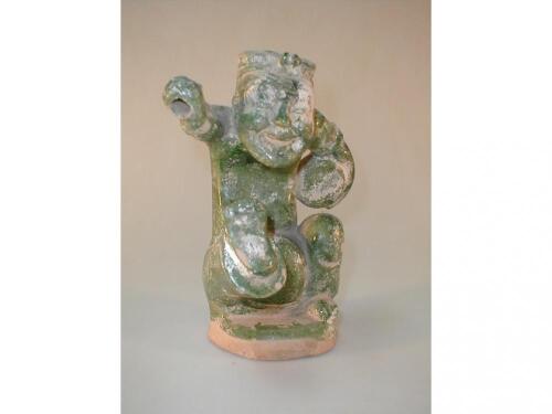 A T'ang green glazed figure of a seated Chinaman