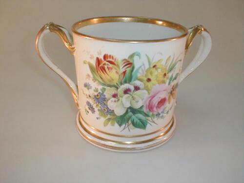 A 19thC porcelain loving cup with two birfucated handles