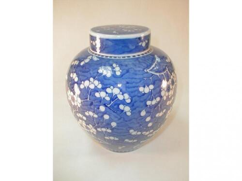 A Chinese blue and white ginger jar decorated with prunus blossom and bearing
