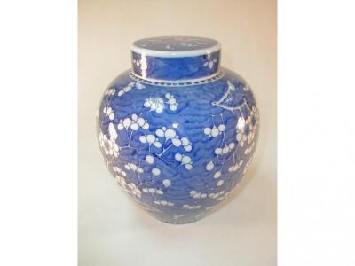 A Chinese blue and white ginger jar decorated with prunus blossom and bearing