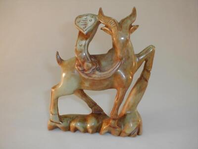 A Chinese soapstone or bowenite figure of a prancing deer