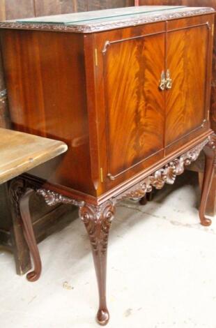 A flame mahogany finish cocktail cabinet