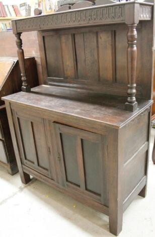 A 20thC oak Jacobean style court cupboard