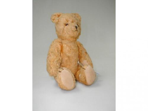 An articulated gold plush teddy bear