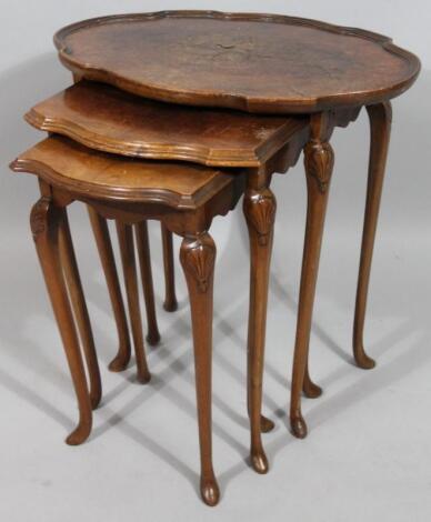 A nest of three 1930's walnut veneered tables