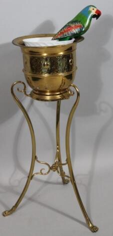 An early 20thC Arts and Crafts brass jardiniere stand