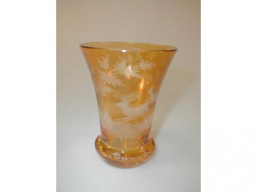 A Bohemian amber glass flared beaker with wheel cut scenes of stag and deer