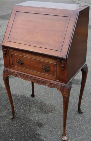 A narrow mahogany bureau.