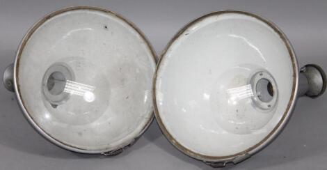 A pair of industrial metal cased and glazed spotlight lamps