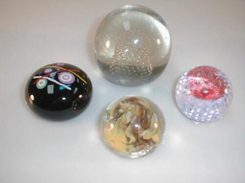 A Caithness Lacemaker paperweight; three further paperweights