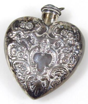 A silver heart shaped perfume bottle