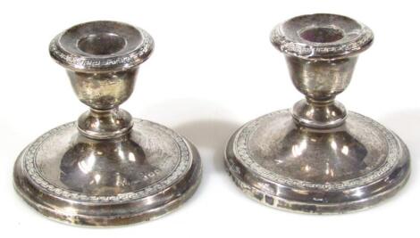 A matched pair of silver dwarf candlesticks