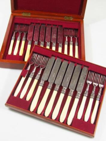 A cased mahogany canteen of table knives and forks