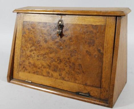 An Edwardian oak and burr wood pipe rack