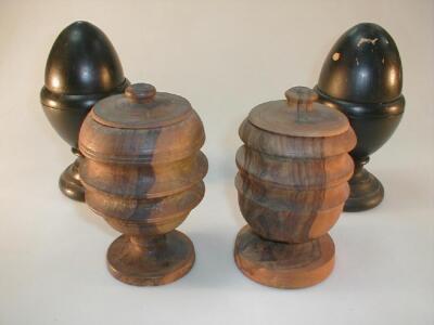 A pair of yew turned urns with covers and a pair of turned acorn finials