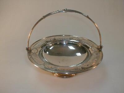 An Elkington & Co Electroplate cake basket of circular pierced form with swing handle