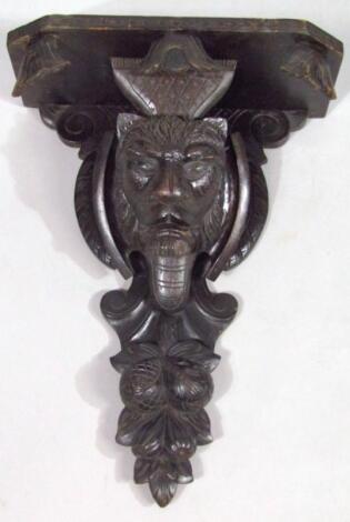 A heavily carved oak wall bracket