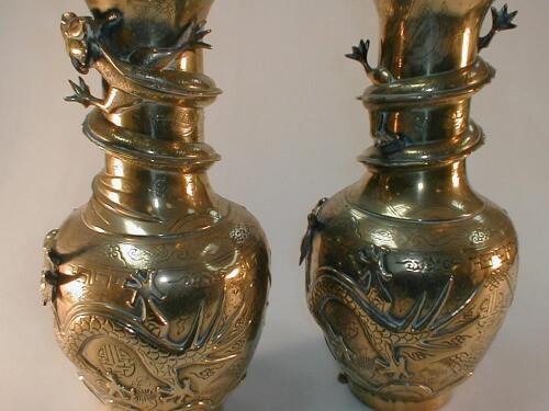 A pair of Chinese brass baluster vases with relief decoration and seal mark to base