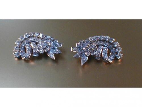 A pair of ear-clips of stylised floral form set with round brilliant cut diamonds