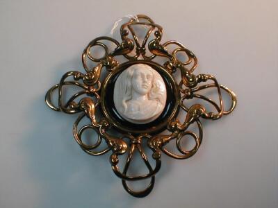 An Art Nouveau carved ivory cameo plaque of a girl's head and shoulders