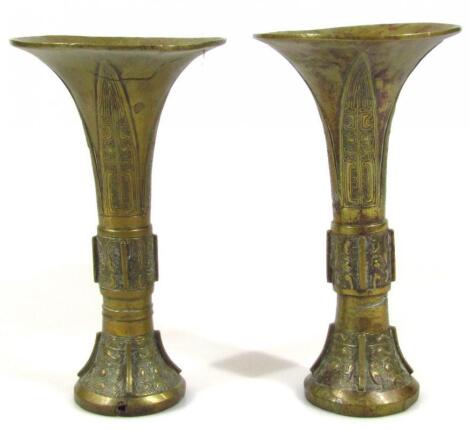 A pair of Fars style brass candlesticks