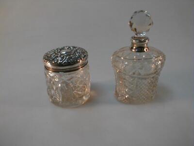 An Edwardian silver neck cut crystal cologne bottle and a dressing table