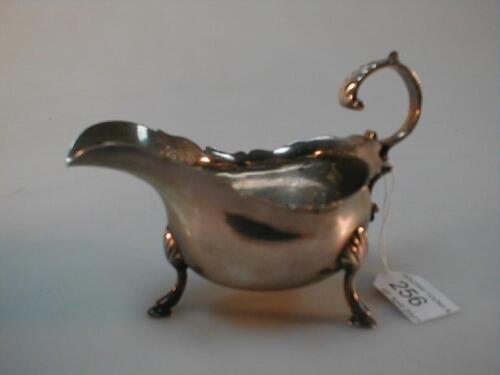 An Edwardian silver sauce boat with flying scroll handle