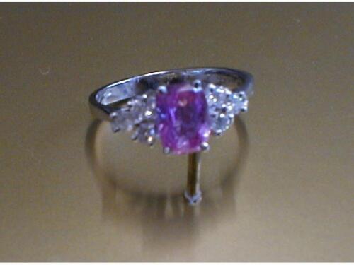 A pink sapphire and diamond ring