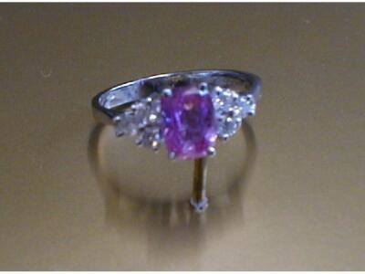 A pink sapphire and diamond ring