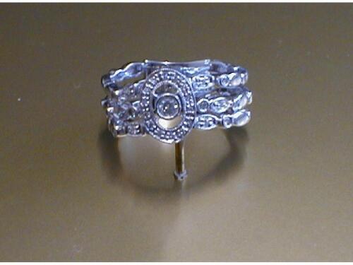 A flexible diamond set ring in white metal stamped 750