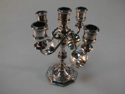 A Georgian style electroplate candelabrum and three eastern silver napkin rings