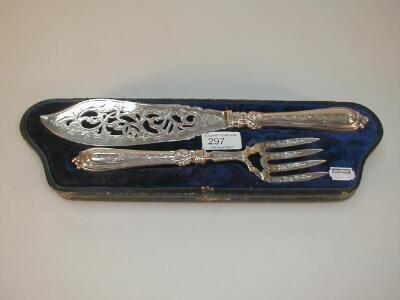 A cased pair of Victorian silver fish servers with chased and pierced blades