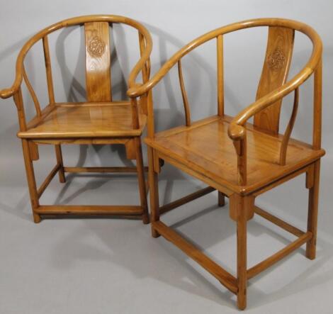 A pair of Chinese polished hardwood moon back chairs