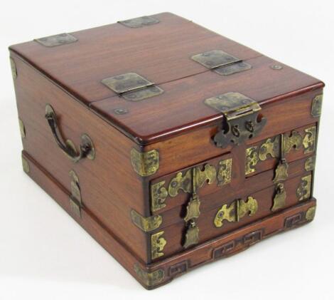 A polished wooden oriental design jewellery casket