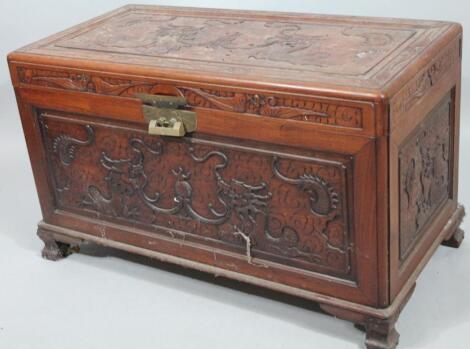 A carved camphor wood blanket chest.